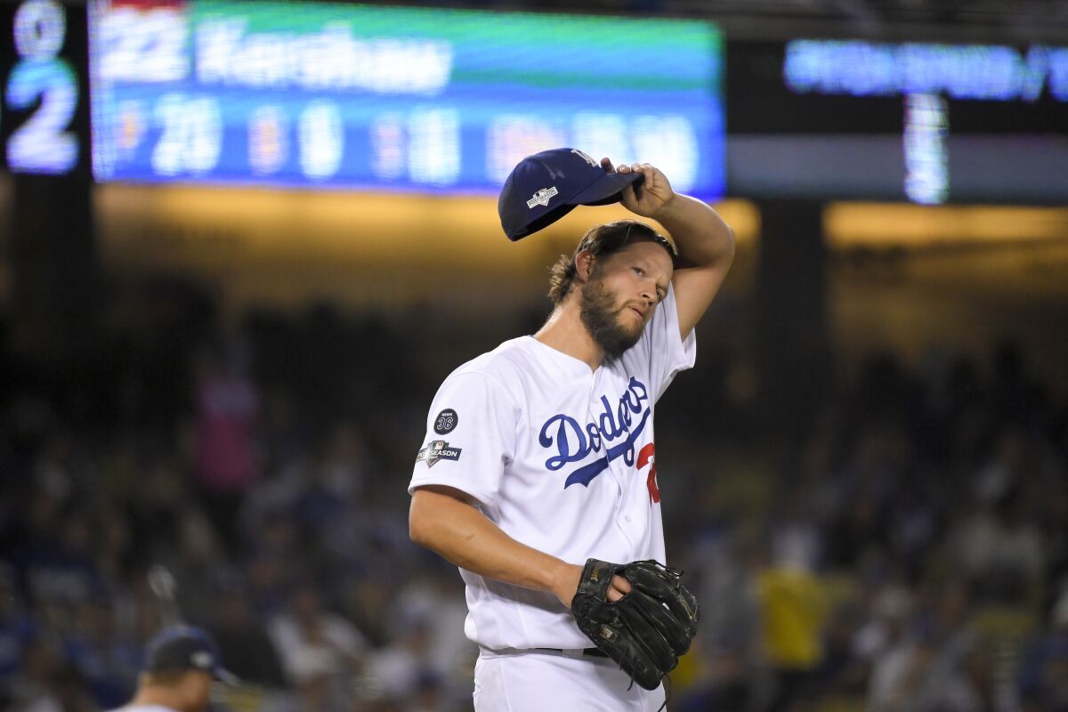 Los Angeles Dodgers starting pitcher Clayton Kershaw wipes his face during the first inning in Game 2.