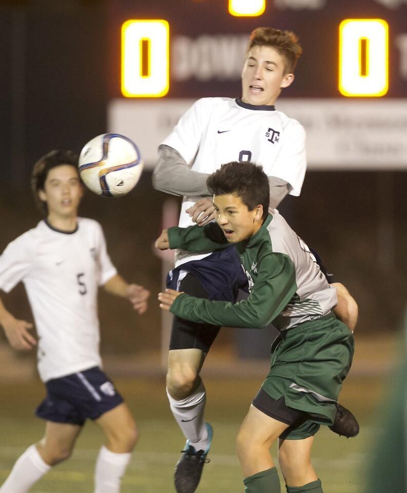 Sage Hill School's Bobby Briggs collides with a St. Margaret's defender at midfield in a key Academy League game on Friday.