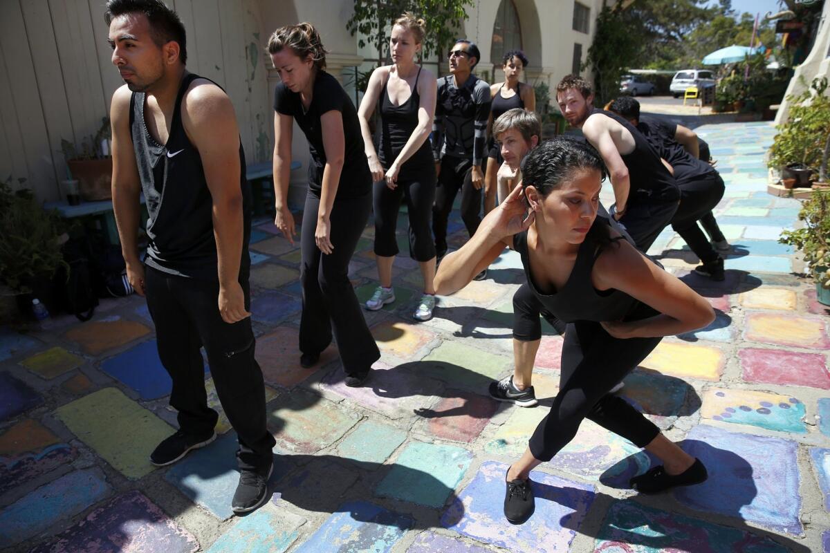 Performers practice their "Trolley Dances" choreographed presentation in Balboa Park's Spanish Village, led by dancer and choreographer Mark Haim. "Trolley Dances" is held all over the region over two weekends, starting this weekend. Nancee E. Lewis