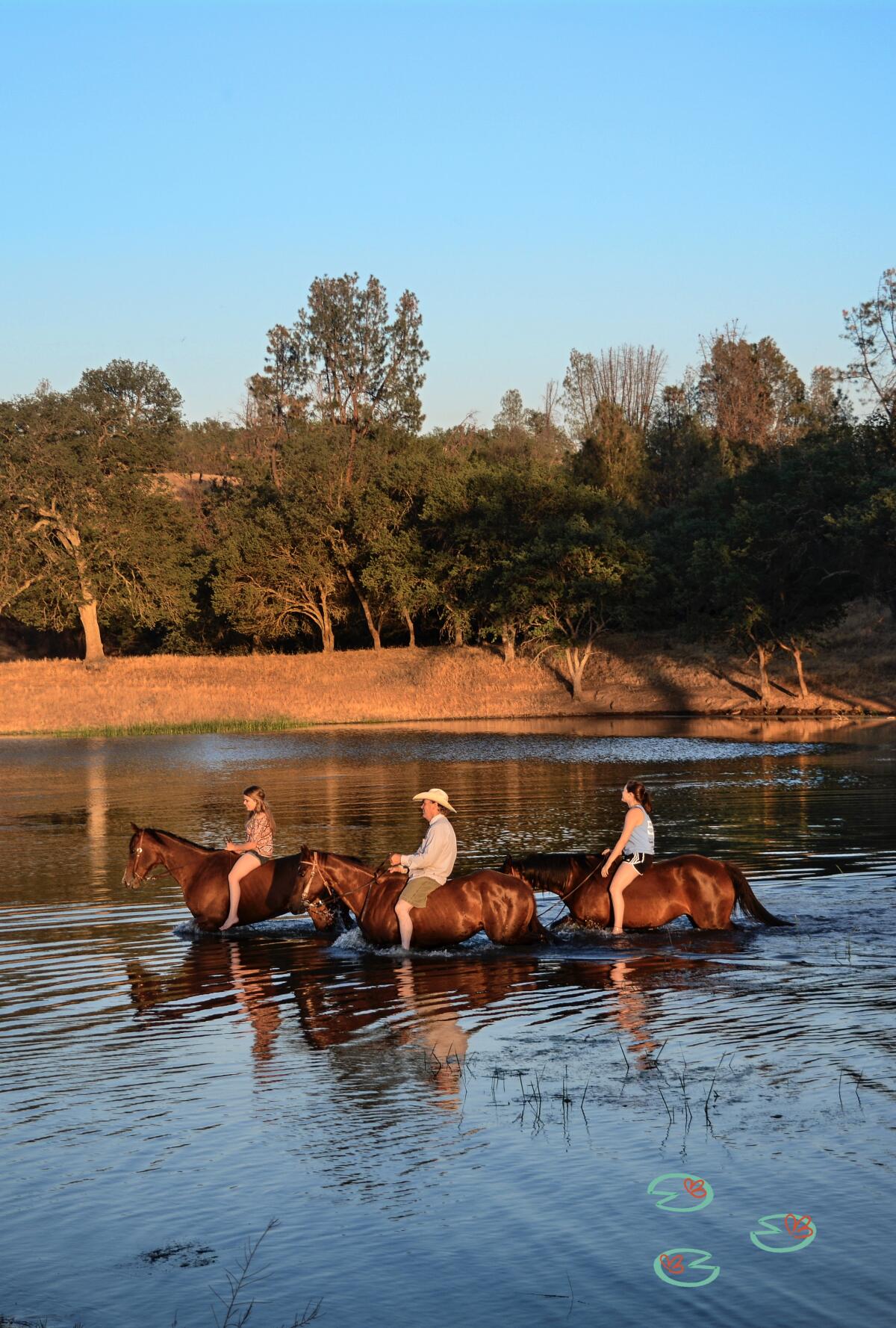 Horses and riders cool down on Durhan Lake at the V6 Ranch in Parkfield, Calif.