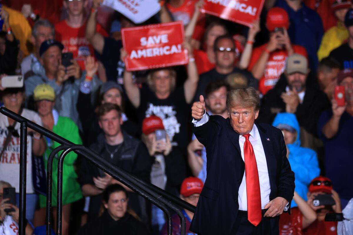 Former President Trump gives a thumbs-up as he finishes addressing a rally