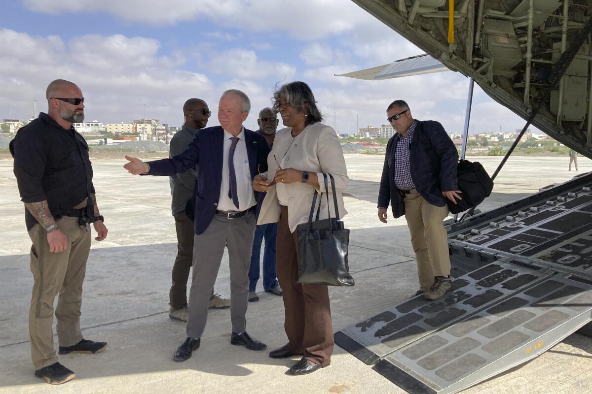 The U.S. ambassador to the United Nations, Linda Thomas-Greenfield, center, is welcomed by U.S. ambassador to Somalia Larry Andre, center left, on her arrival in Mogadishu, Somalia Sunday, Jan. 29, 2023. The first U.S. Cabinet member to visit Somalia in nearly a decade is urging the world's distracted donors to give immediate help to a country facing deadly famine, which she calls "the ultimate failure of the international community." (AP Photo/Cara Anna)