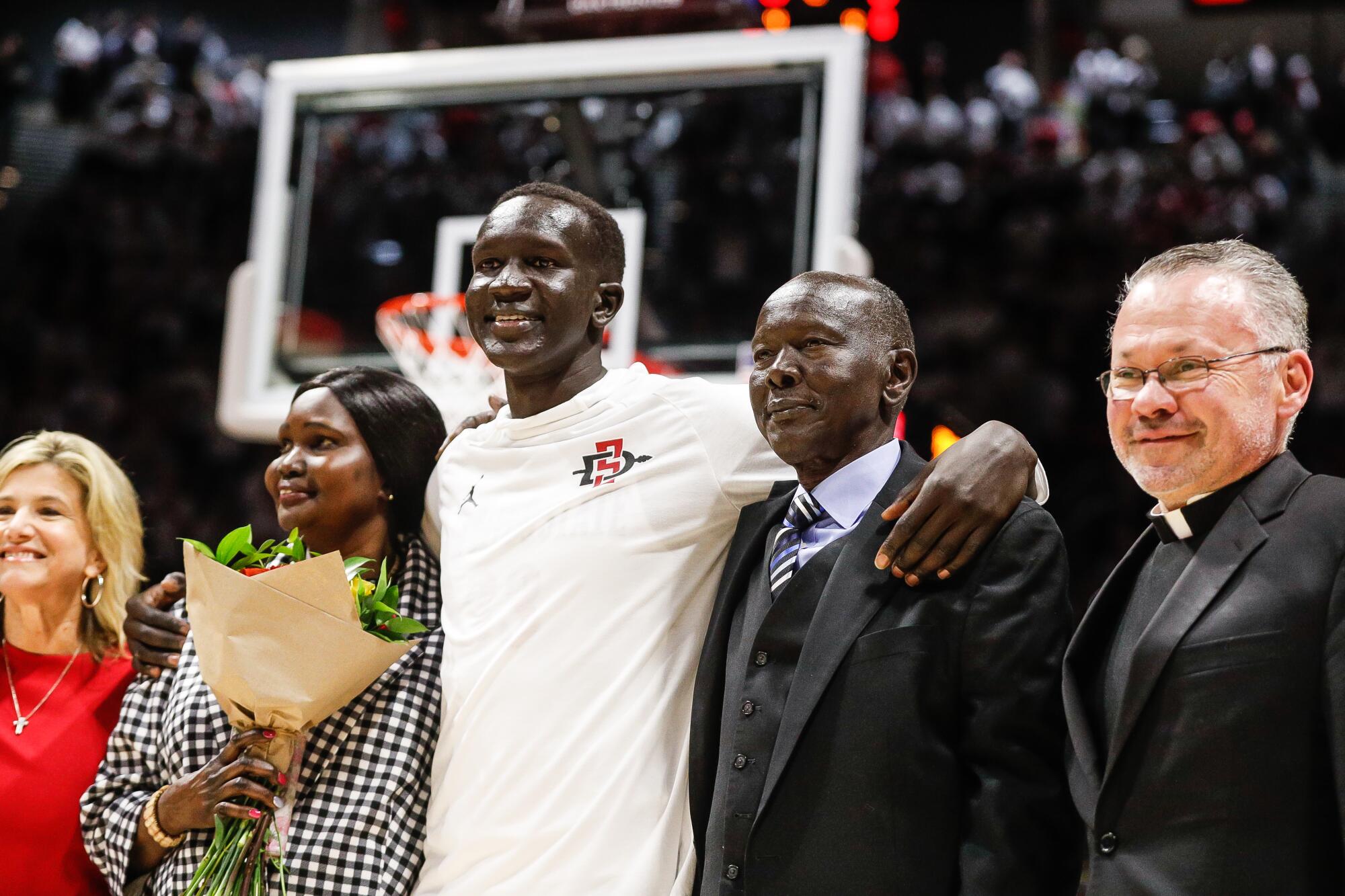 San Diego State forward Aguek Arop poses for a photo with family 