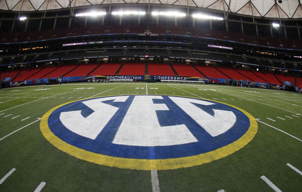 FILE - In this Dec. 5, 2014, file photo, the SEC logo is displayed on the field ahead of the Southeastern Conference championship football game between Alabama and Missouri in Atlanta. The Southeastern Conference will play only league games in 2020 to deal with potential COVID-19 disruptions, a decision that pushes major college football closer to a siloed regular season in which none of the power conferences cross paths(AP Photo/John Bazemore, File)