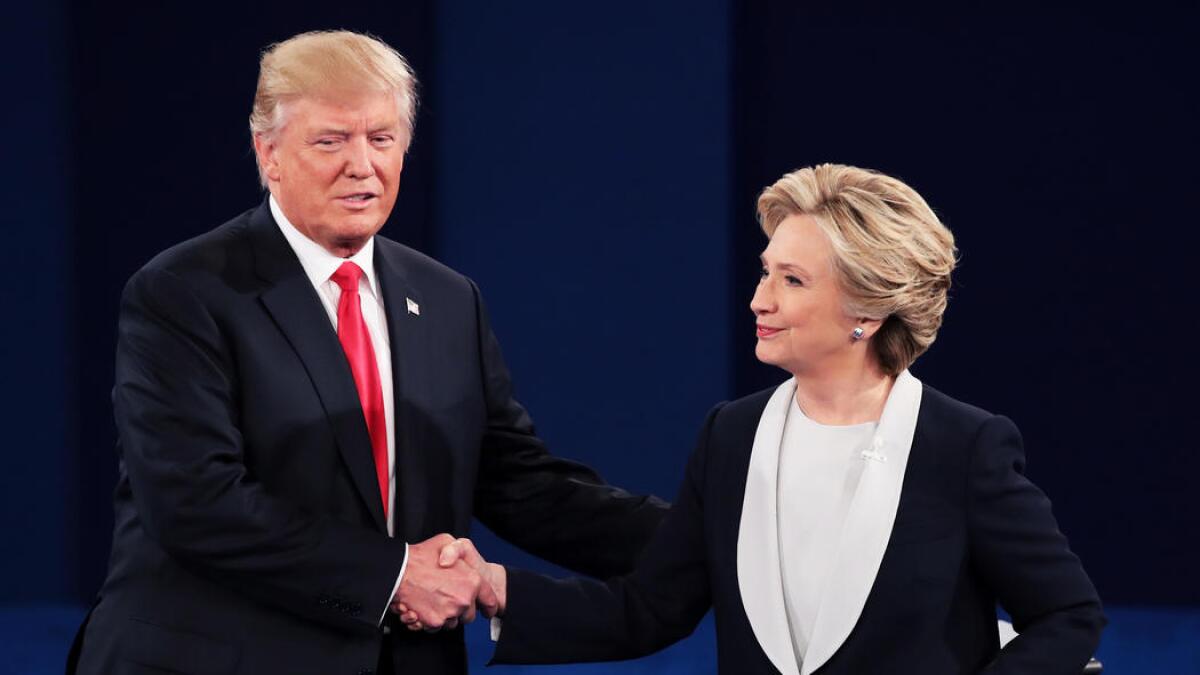 Donald Trump and Hillary Clinton shake hands at the second presidential debate.