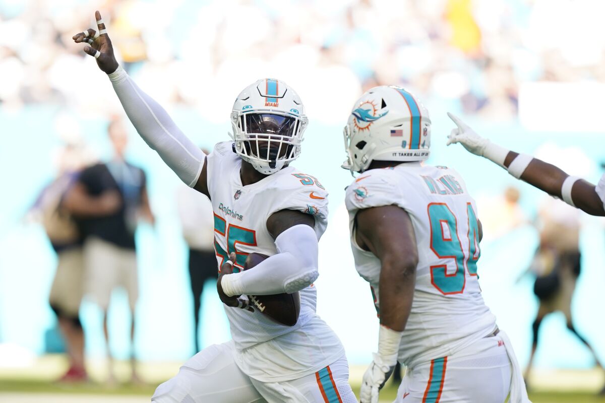 Miami Dolphins outside linebacker Jerome Baker (55) celebrates after intercepting a pass during the first half of an NFL football game against the Houston Texans, Sunday, Nov. 7, 2021, in Miami Gardens, Fla. (AP Photo/Wilfredo Lee)