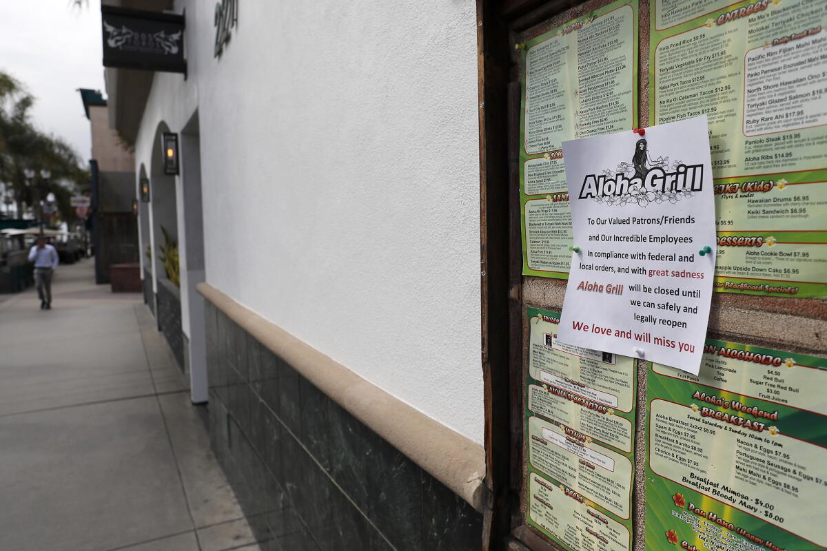 A note posted at Aloha Grill in downtown Huntington Beach announces the restaurant is closed until further notice.