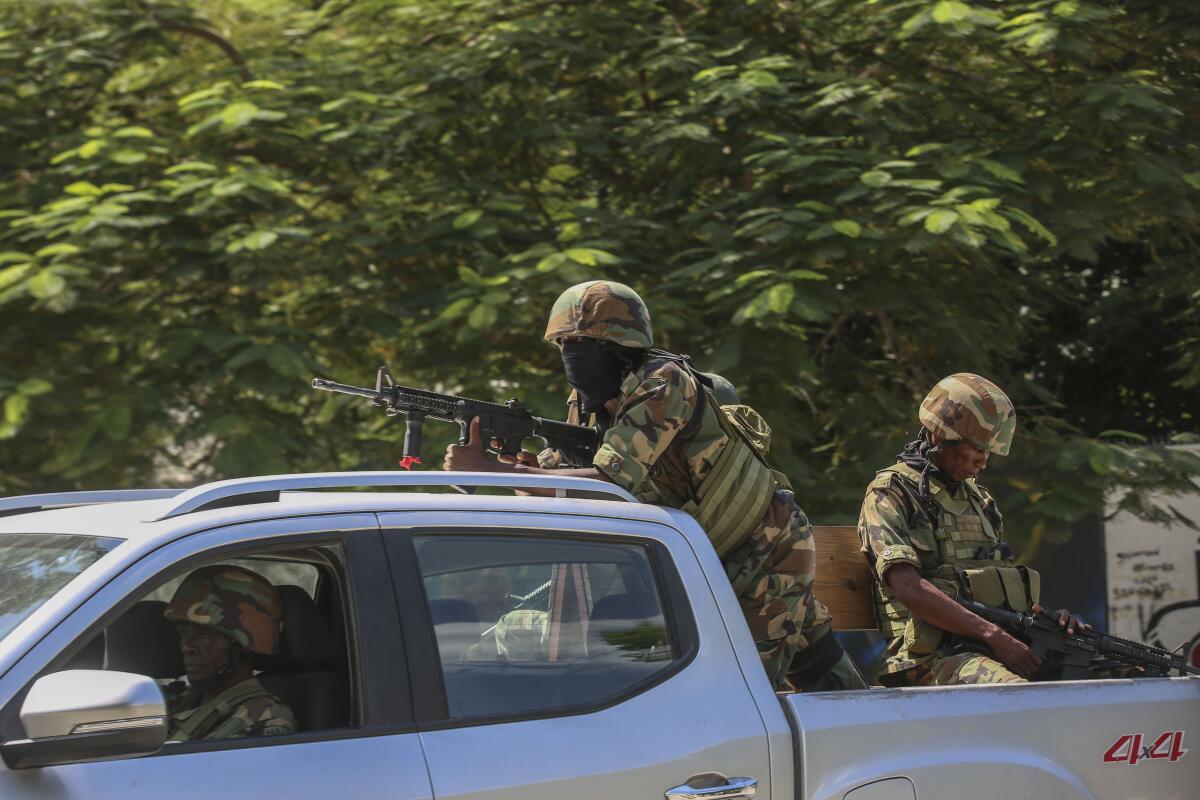 Soldiers patrol amid the sound of gunshots heard in the distance, in Port-au-Prince, Haiti.