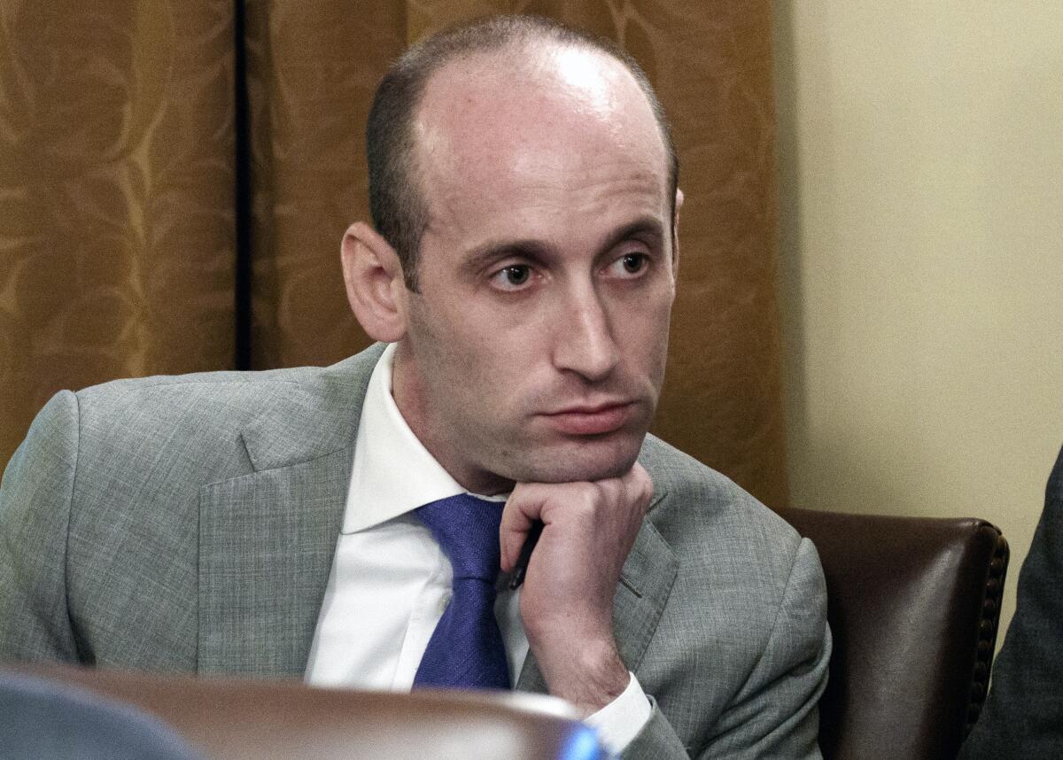 Stephen Miller, in a file photo, listens with chin on hand.