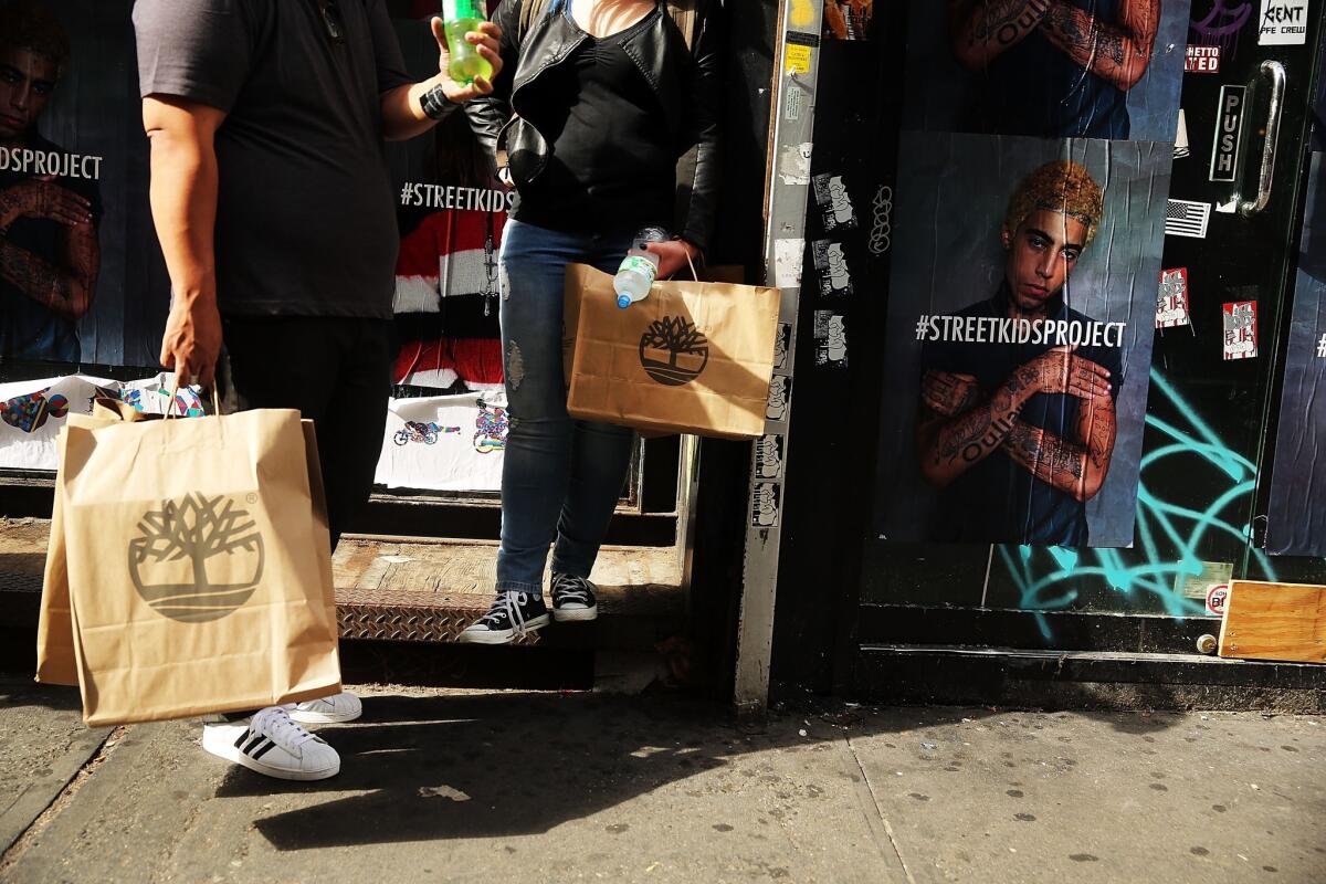 People hold shopping bags along Broadway in New York City on Oct. 15.