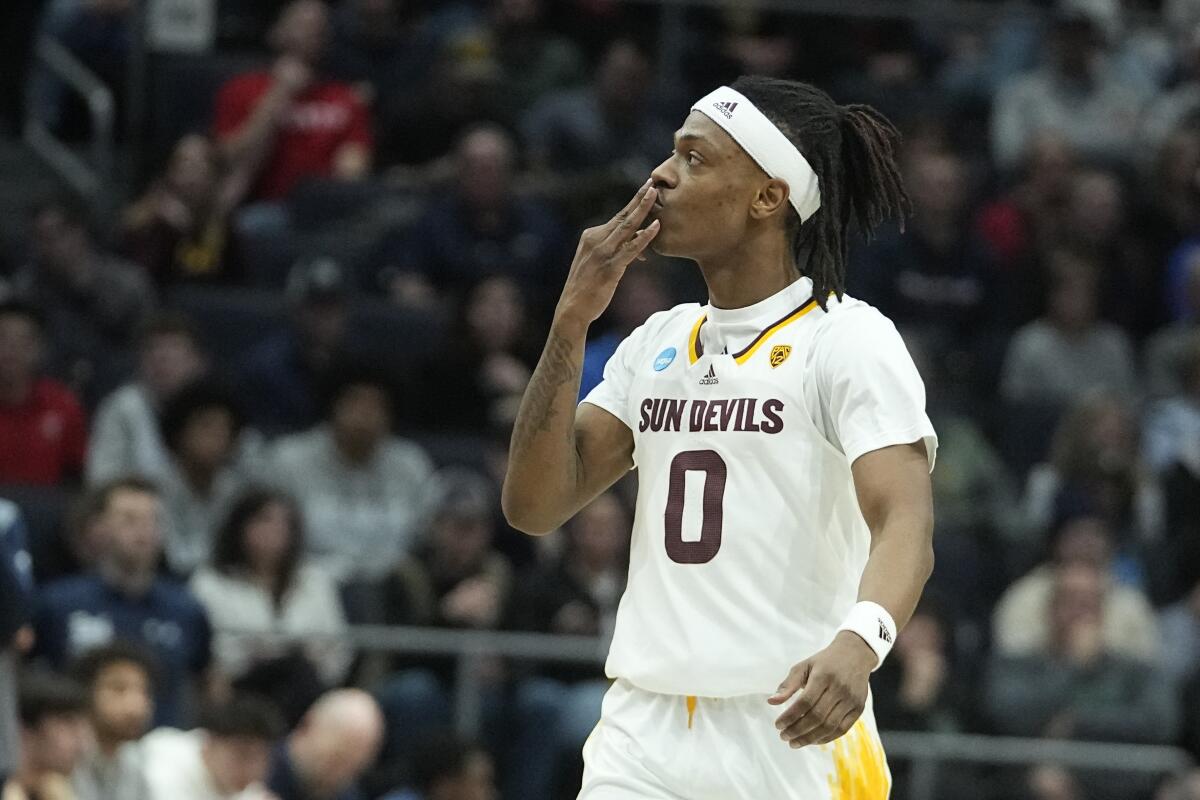 Arizona State's DJ Horne reacts after hitting a three-point shot during the first half of a First Four game against Nevada.