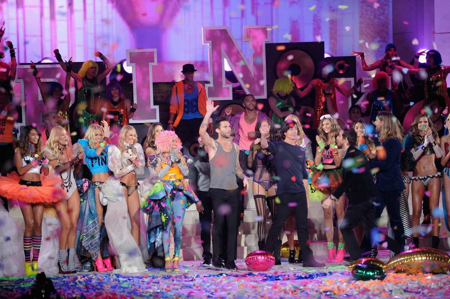 Nicki Minaj, Adam Levine and band members of Maroon 5 pose with models on the runway during the 2011 Victoria's Secret Fashion Show at the Lexington Avenue Armory in New York City. Along with Kanye West and Jay-Z, the fashion-conscious musicians performed on the runway stage.