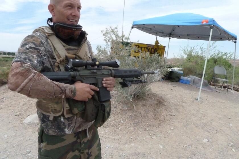 Militia member John Logan of Waco, Texas, stands at his sentry post outside the Cliven Bundy ranch in Nevada in April.