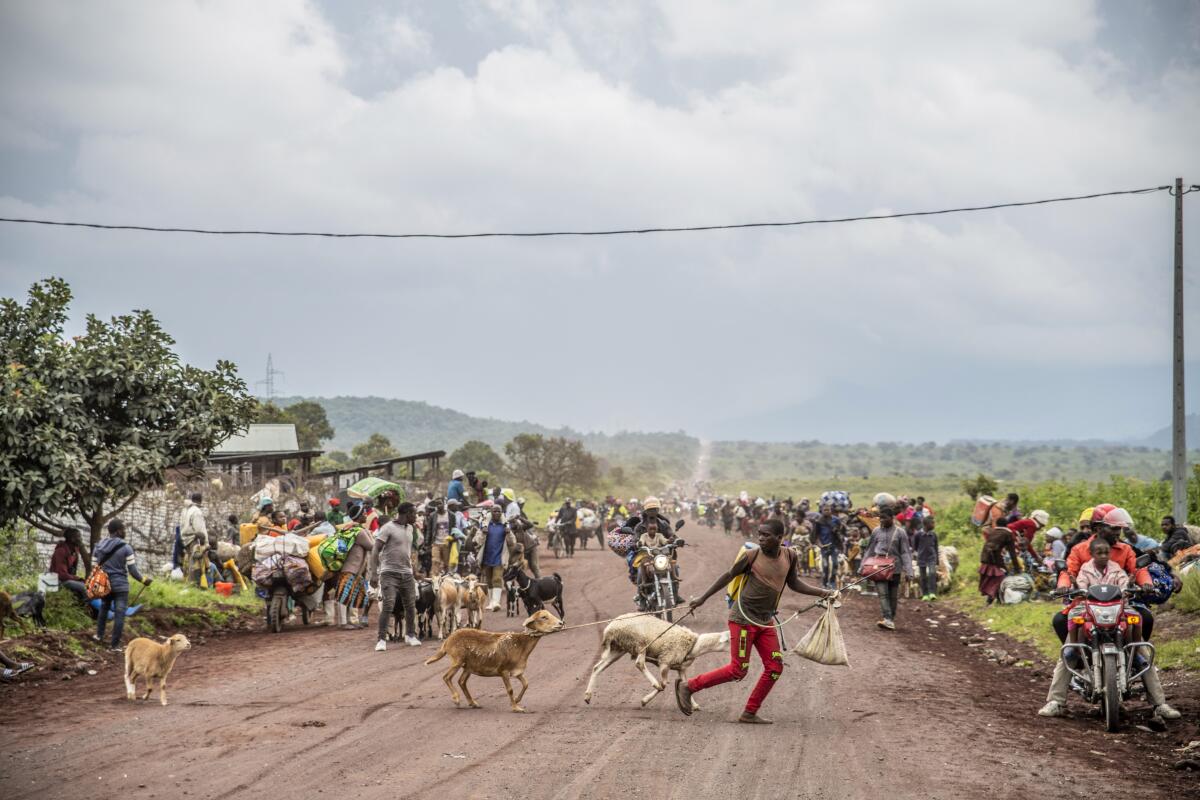 People walk on the road near Kibumba, north of Goma, Democratic Republic of Congo