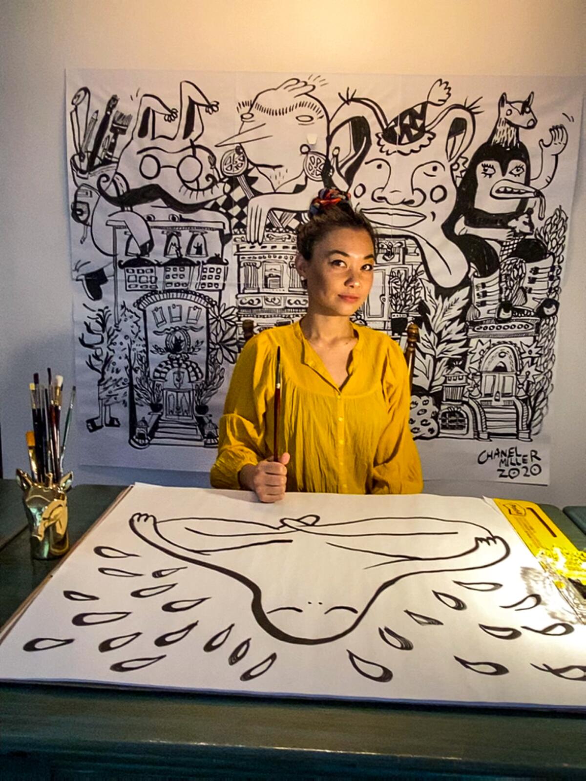 Chanel Miller sits before a large wall drawing in her New York apartment