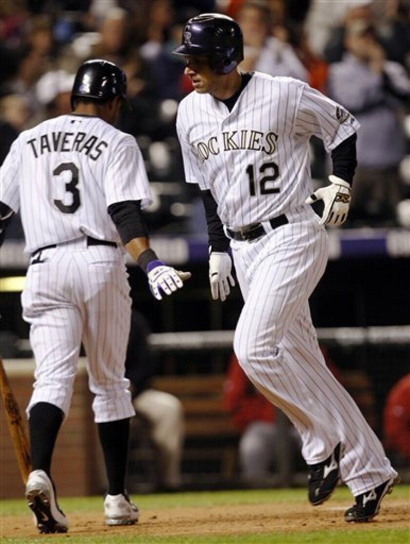 Colorado Rockies' Clint Barmes, right, is congratulated by Willy Taveras as Barmes crosses home plate after hitting a solo home run against the Houston Astros in the fifth inning of the Rockies' 5-3 victory in a baseball game in Denver on Friday, Sept. 5, 2008. (AP Photo/David Zalubowski)