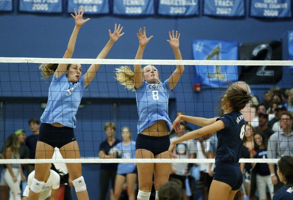 Corona del Mar High's Blair Hodges (9) and Brooke Cuthbertson (8) reach for a ball that went wide in the Battle of the Bay against Newport Harbor.