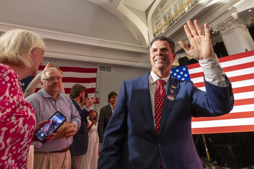 FILE - Virginia state Sen. John McGuire, a candidate in the Republican primary in the state's 5th Congressional District, joins supporters June 18, 2024, in Lynchburg, Va. (AP Photo/Skip Rowland, File)