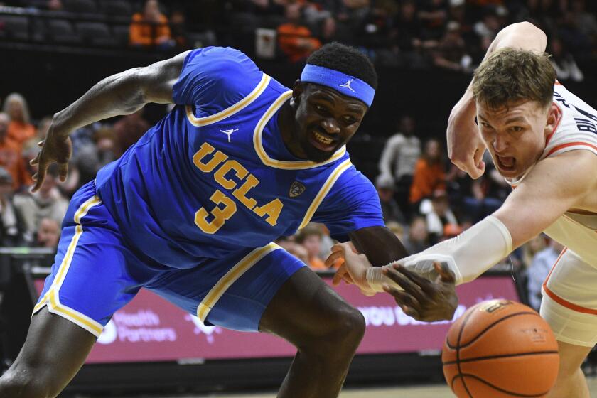 Oregon State forward Tyler Bilodeau (34) knocks the ball away from UCLA forward Adem Bona (3) during the second half of an NCAA college basketball game Thursday, Dec. 28, 2023, in Corvallis, Ore. (AP Photo/Mark Ylen)