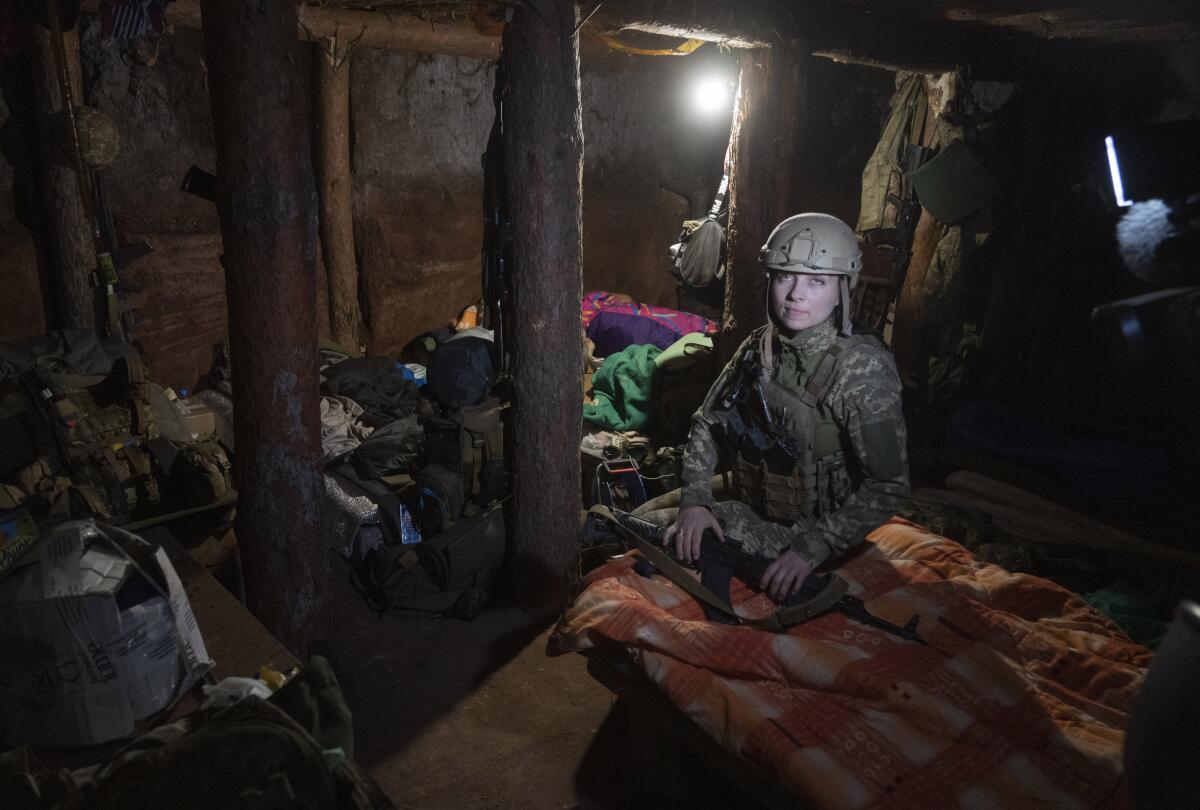 Ukrainian platoon commander sitting in trench quarters.
