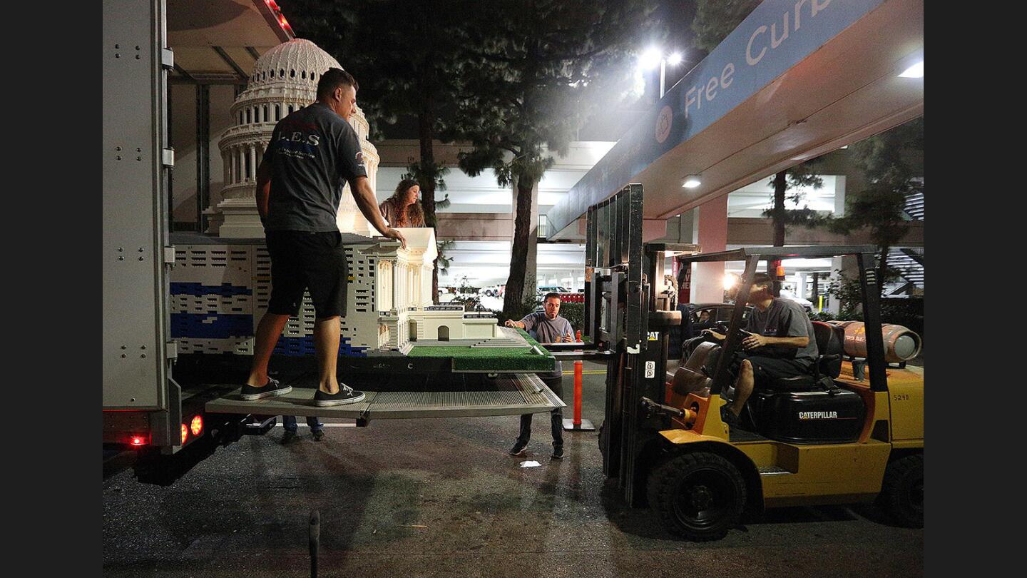 Installers, with the help of a fork lift, extract a very large Lego model of the U.S. Capitol from a long semi trailer for the installation of the Lego Americana Roadshow at the Glendale Galleria on Wednesday night, May 10, 2017. Ten national monuments, mostly models of buildings in Washington, D.C., will be on display throughout the mall.
