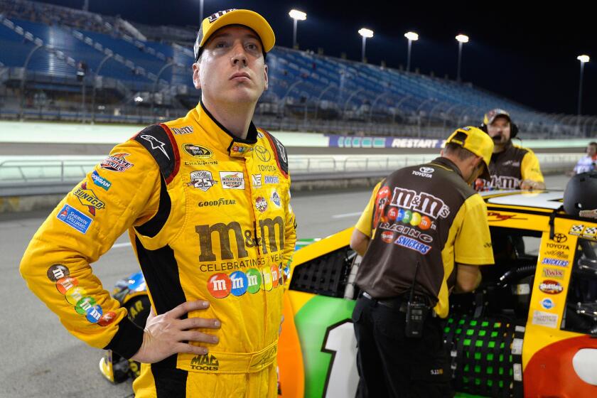 NASCAR driver Kyle Busch stands on the grid at Homestead-Miami Speedway on Friday during qualifying for Sunday's Sprint Cup season finale.