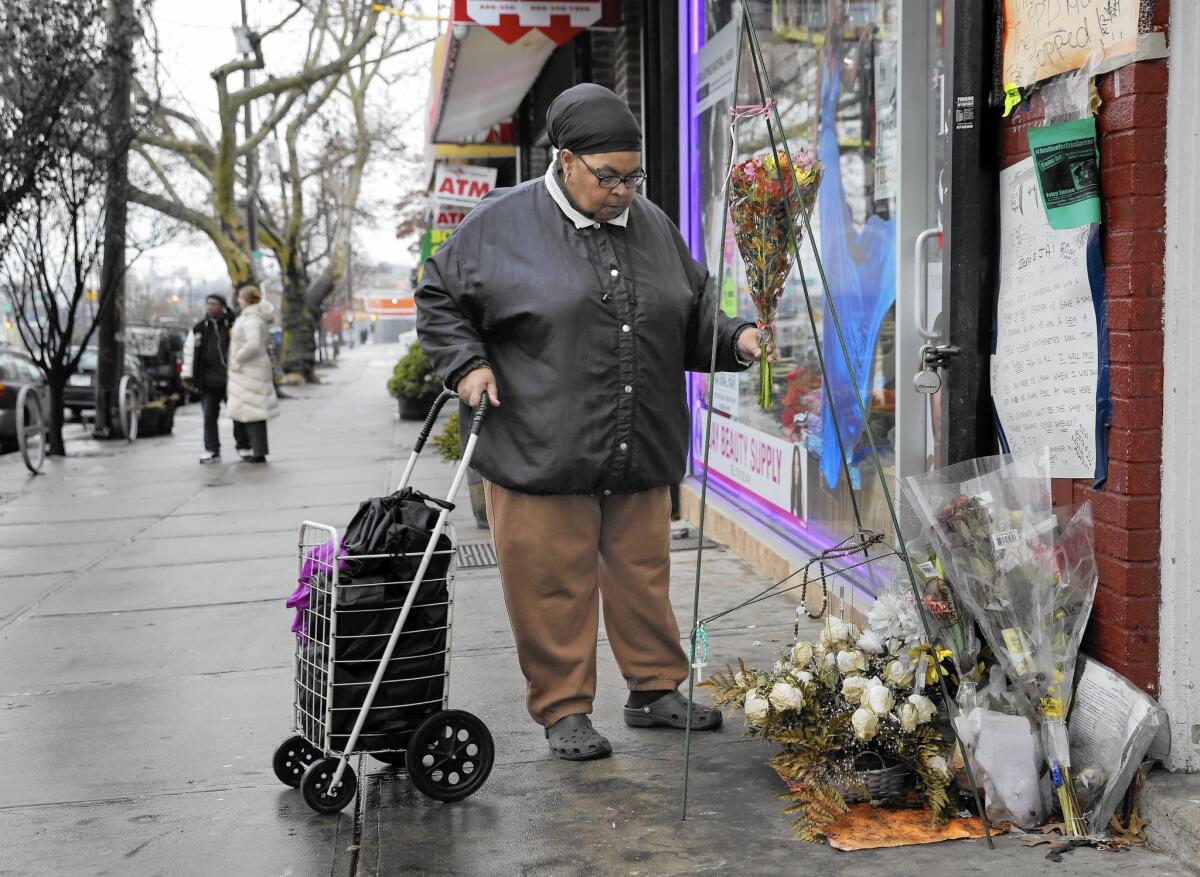 A woman places flowers at a memorial for Eric Garner on Dec. 3 near where he died in Staten Island, N.Y.