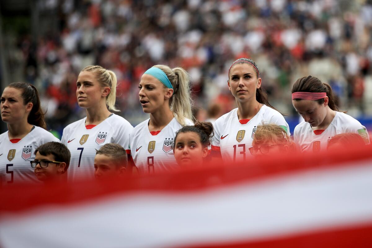 The U.S. women's national team look on during the national anthem.