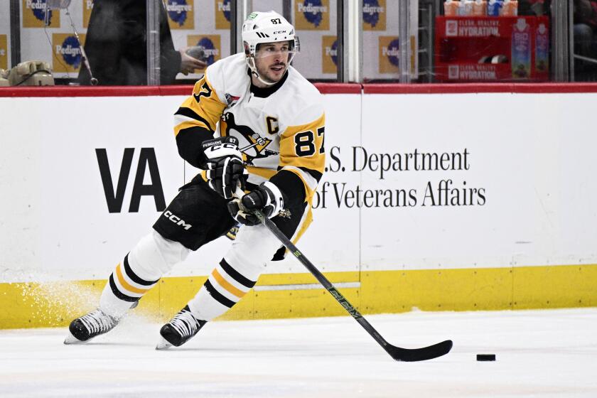 Pittsburgh Penguins center Sidney Crosby (87) skates with the puck during the first period of the team's NHL hockey game against the Washington Capitals, Thursday, April 4, 2024, in Washington. (AP Photo/Nick Wass)