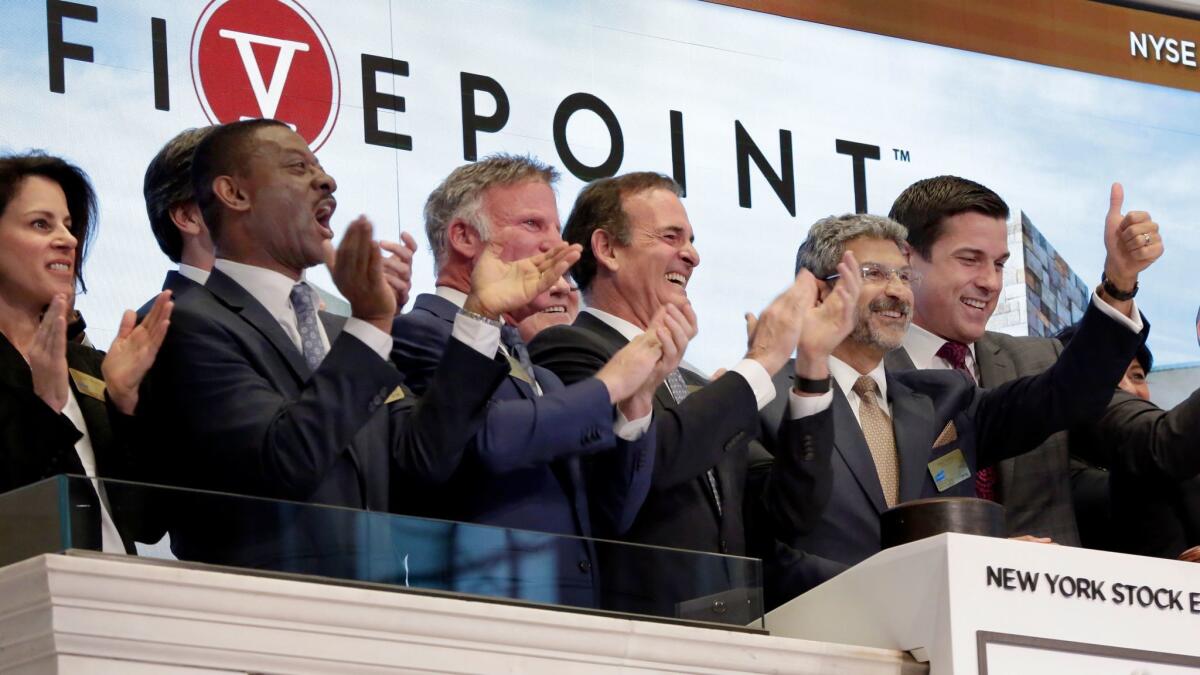 Five Point Holdings Chairman and CEO Emile Haddad, second from right, rings the New York Stock Exchange opening bell before his company's IPO starts trading on May 10.