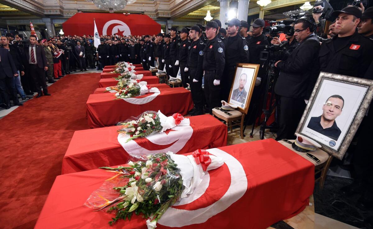 Coffins of the presidential guards who were killed in a bomb blast in central Tunis the previous day are viewed during an official ceremony to honor them on Wednesday.