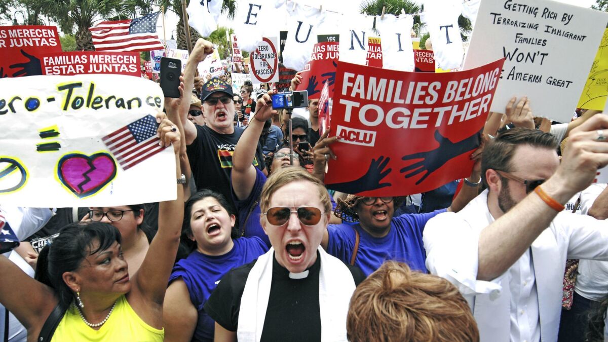Protesters chant, "Families belong together," as they walk to the front doors of the federal courthouse in Brownsville, Texas.