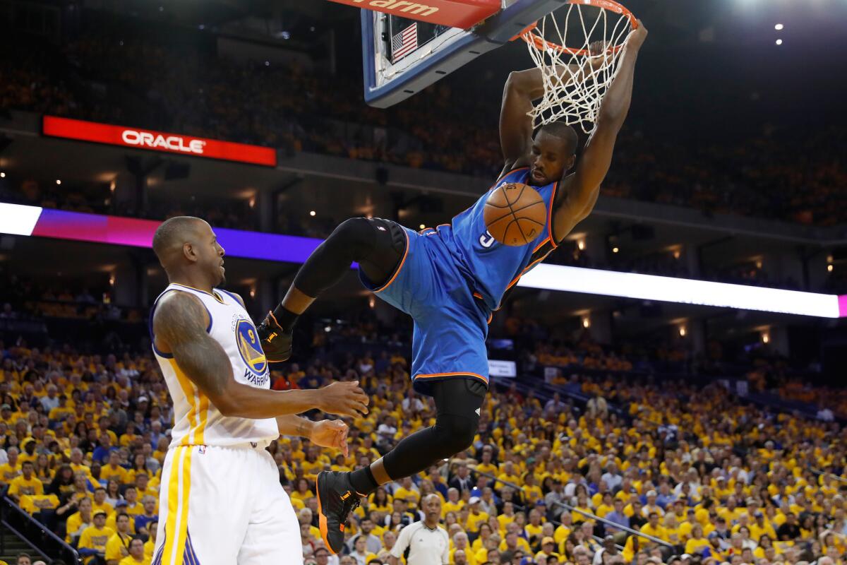 Thunder forward Serge Ibaka (9) dunks the ball against the Warriors during Game 1 of the Western Conference finals.