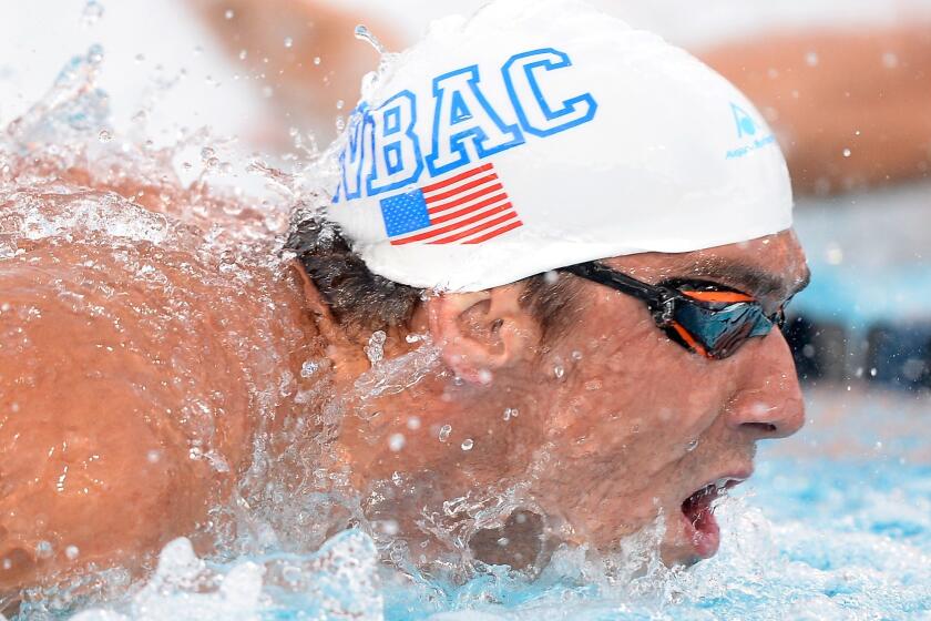 Michael Phelps finished second behind Tom Shields by one one-hundredth of a second at the U.S. national championships on Friday in Irvine.