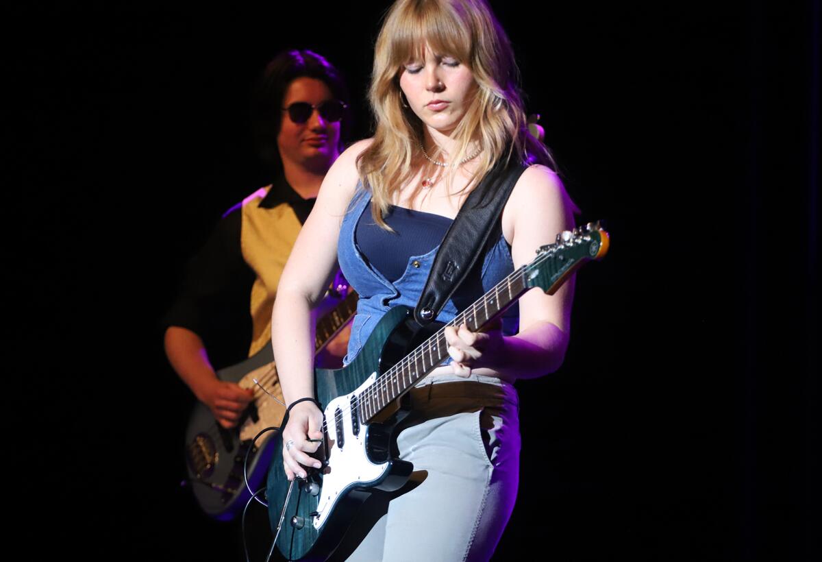 Ava Johnson jams a guitar solo during Retrofest 197.8 rehearsal on Tuesday night.