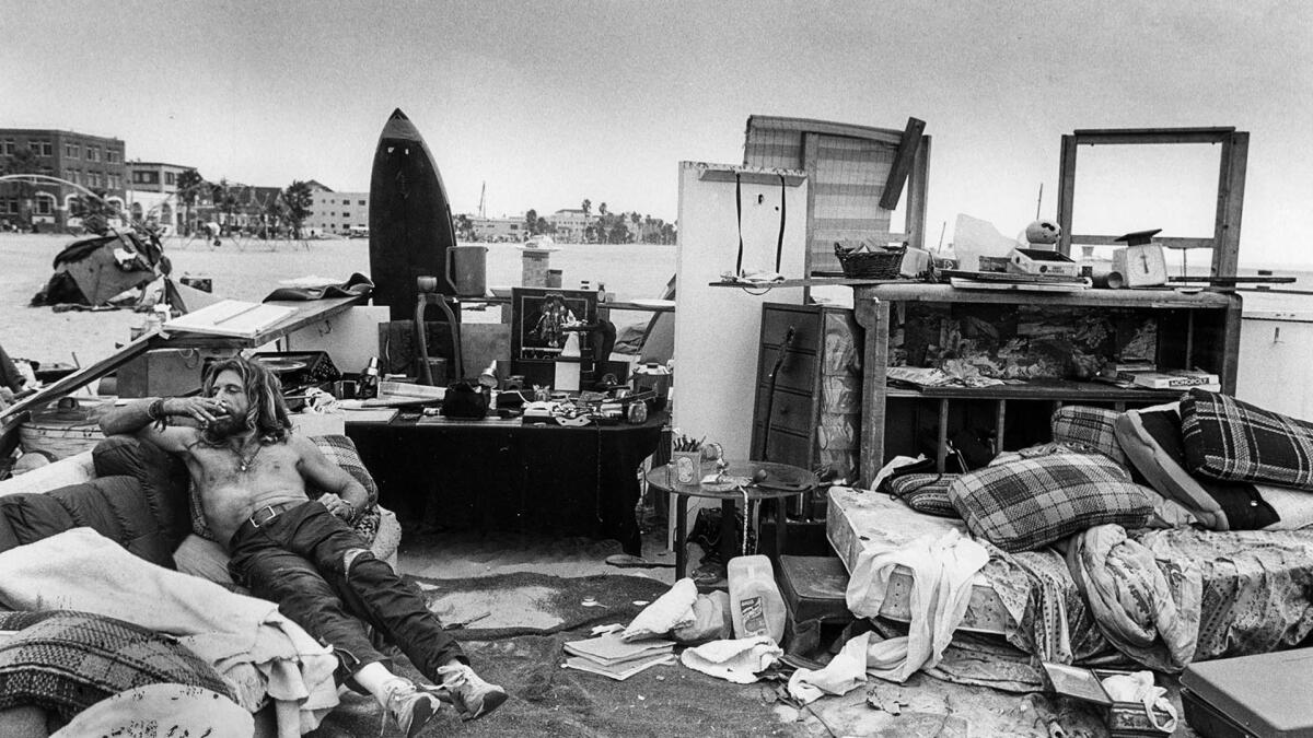 Oct. 20, 1987: James Moore sits on his couch at a homeless encampment on Venice Beach.