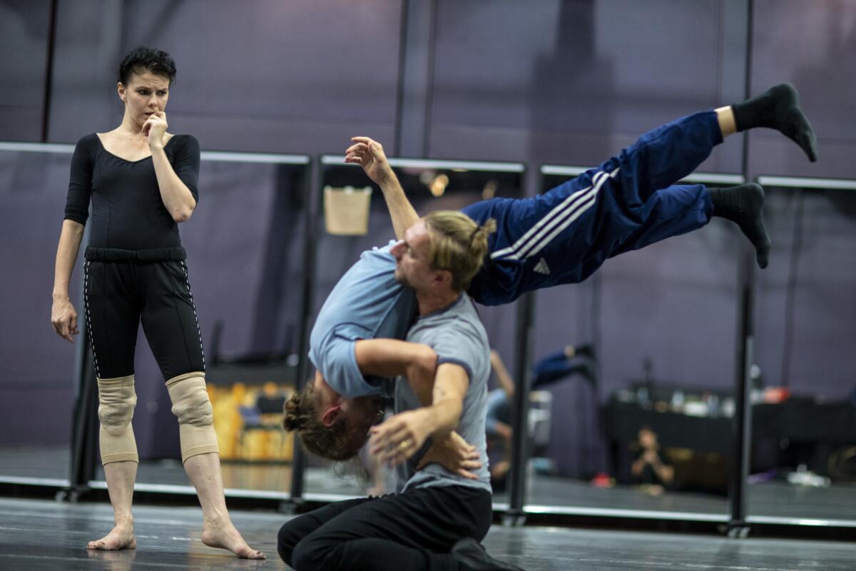 Natalia Osipova, left, watches as Vladimir Dorokhin (on his knees) and choreographer Vladimir Varnava go through a move during rehearsal for "Isadora."