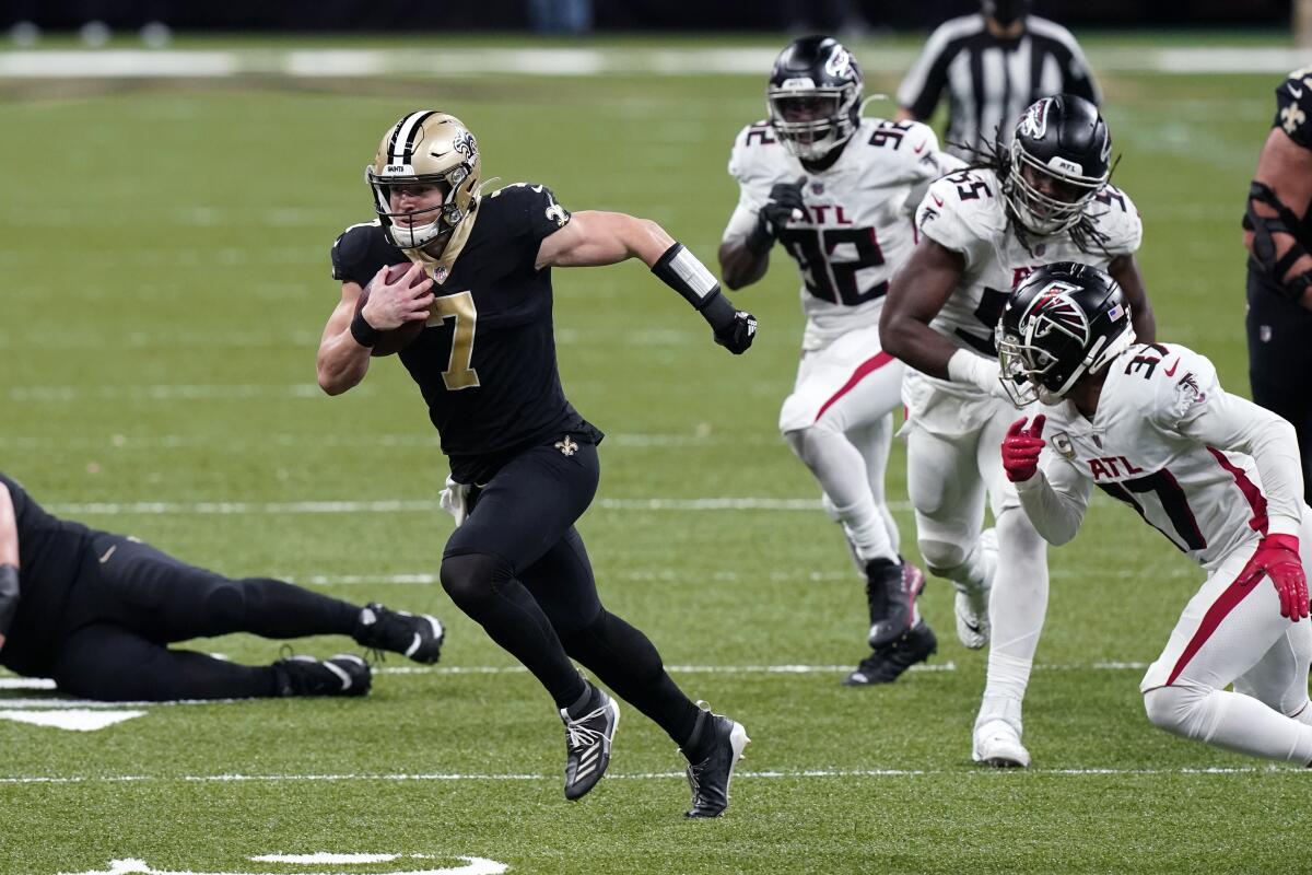 New Orleans Saints quarterback Taysom Hill runs past the Atlanta Falcons defense on Sunday.