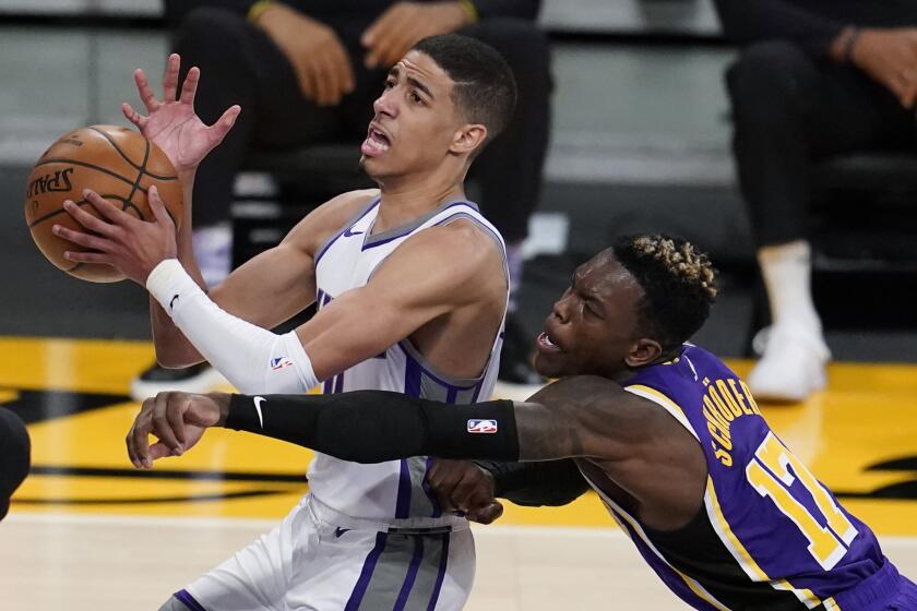 Sacramento Kings guard Tyrese Haliburton, left, drives past Los Angeles Lakers guard Dennis Schroeder (17) during the second half of an NBA basketball game Friday, April 30, 2021, in Los Angeles. (AP Photo/Marcio Jose Sanchez)