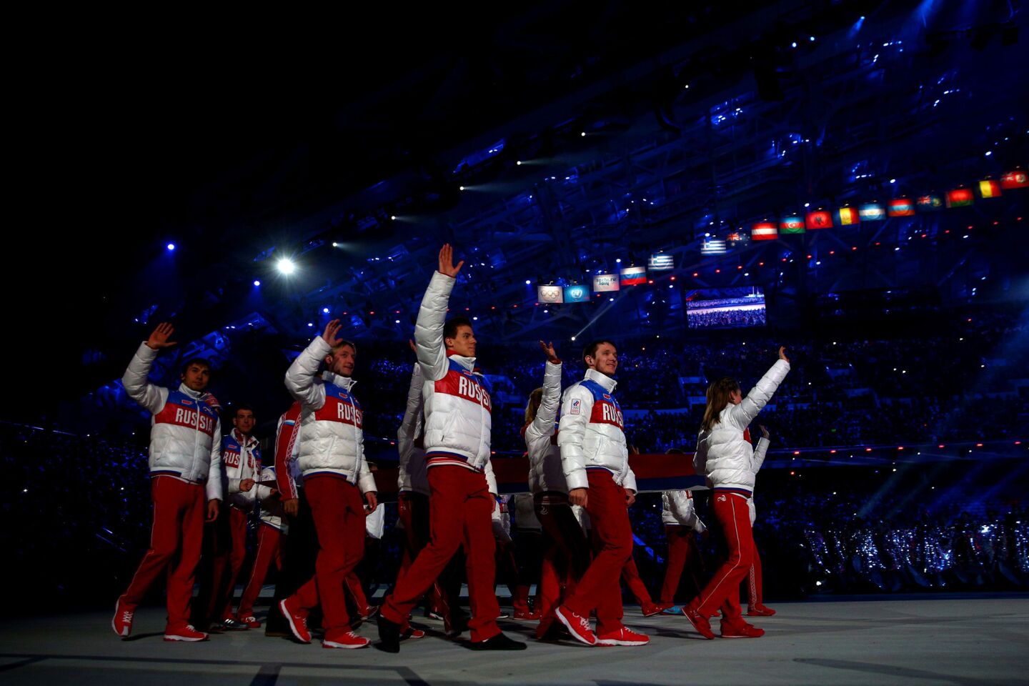 Russian athletes walk in for the 2014 Sochi Winter Olympics Closing Ceremony at Fisht Olympic Stadium in Sochi, Russia.