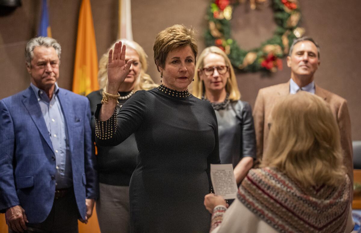 Barbara Delgleize takes the oath of office as the new mayor of Huntington Beach during Tuesday night's City Council meeting.