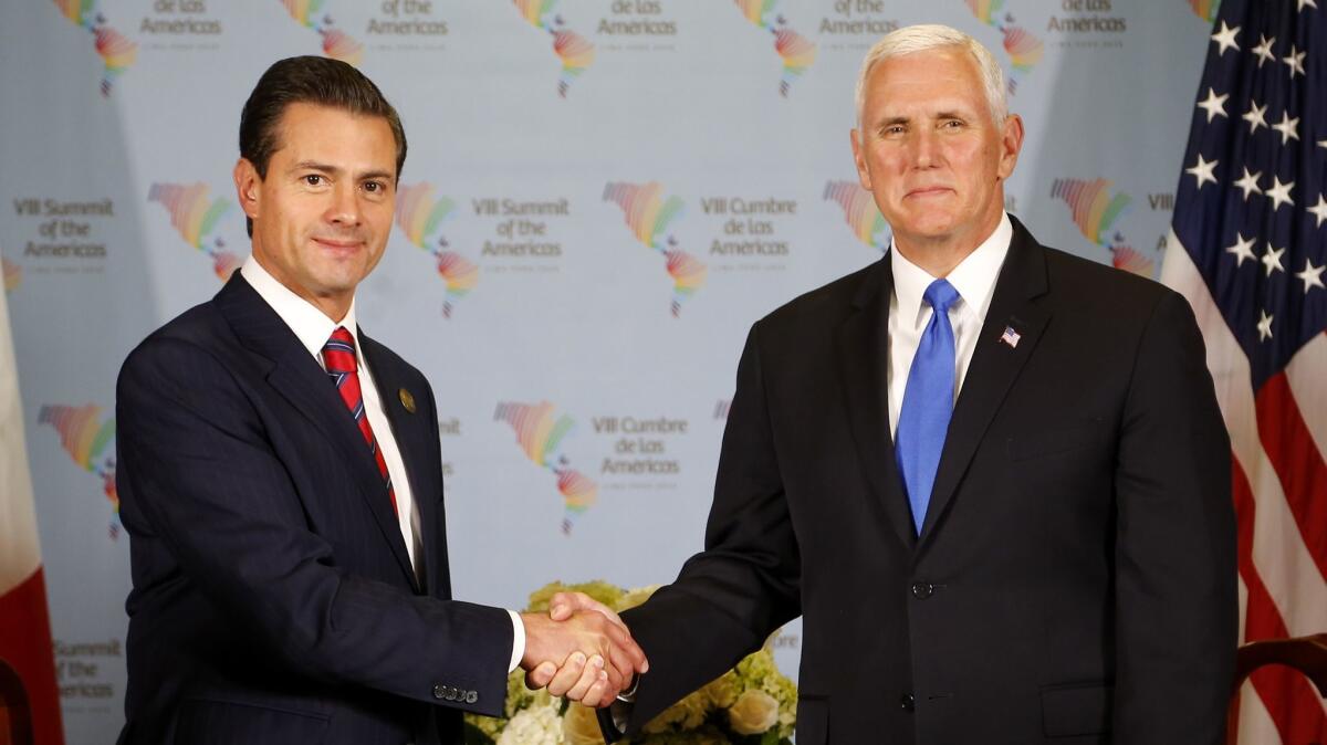 Vice President Mike Pence, right, meets with Mexico's President Enrique Peña Nieto at the Summit of the Americas in Lima, Peru, on Saturday.