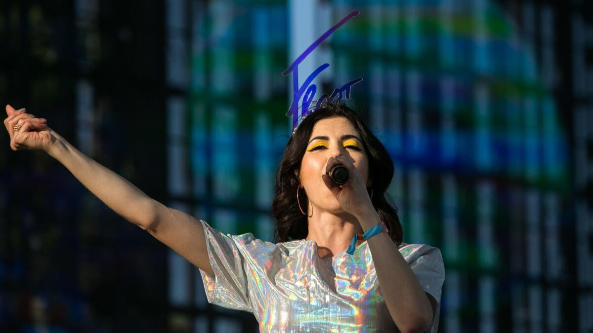 Marina of Marina and the Diamonds wears a custom headpiece by British milliner Piers Atkinson during a 2015 Coachella performance. “The thing about hats is that they are sculptures, and they can be anything,” Atkinson says.