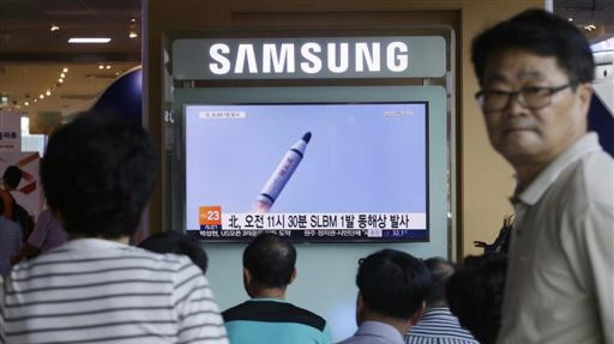 People in Seoul watch a TV news program showing video of a North Korean ballistic missile that the North claimed to have launched on July 9, 2016.