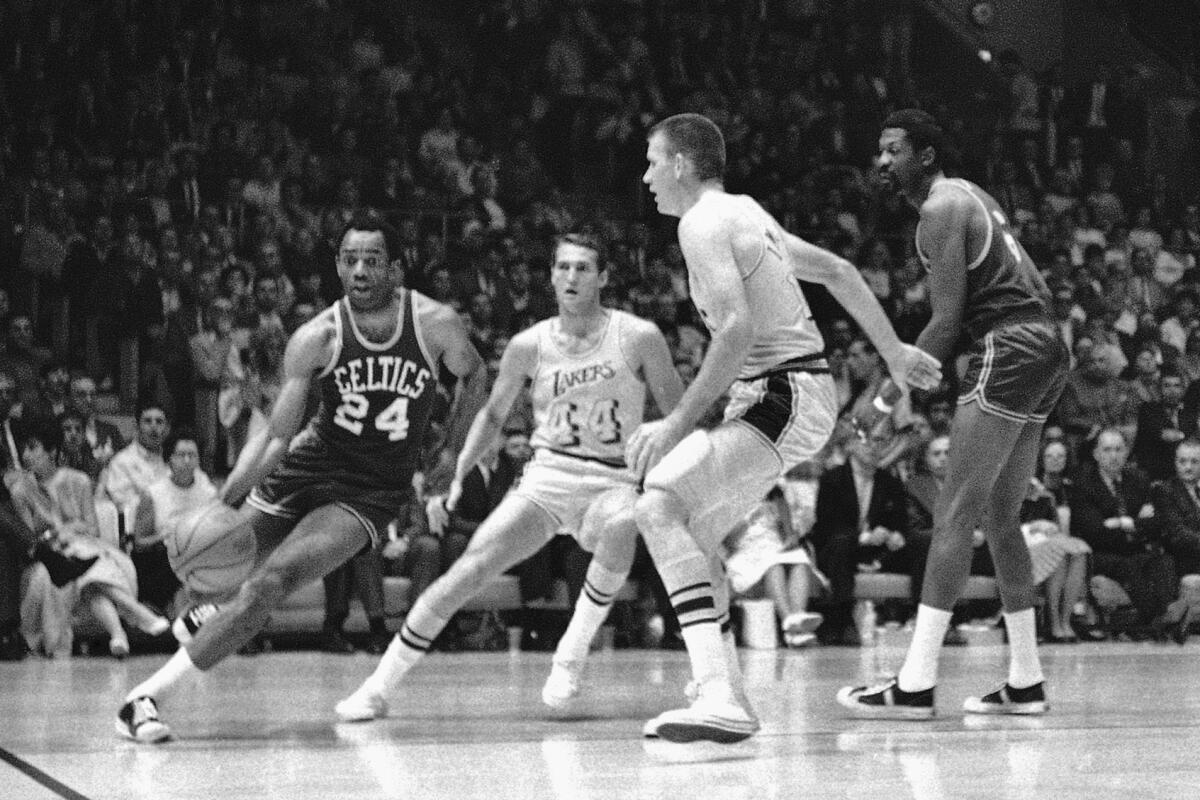 Boston's Sam Jones, left, drives past the Lakers' Jerry West and Darrall Imhoff during a game in 1968.