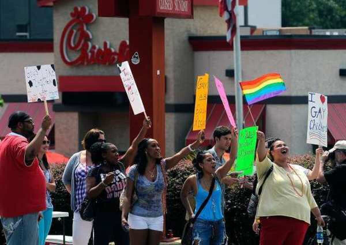 Gay rights groups and others protest and hold a "kiss-in" outside the Decatur, Ga., Chick-fil-A restaurant Friday.