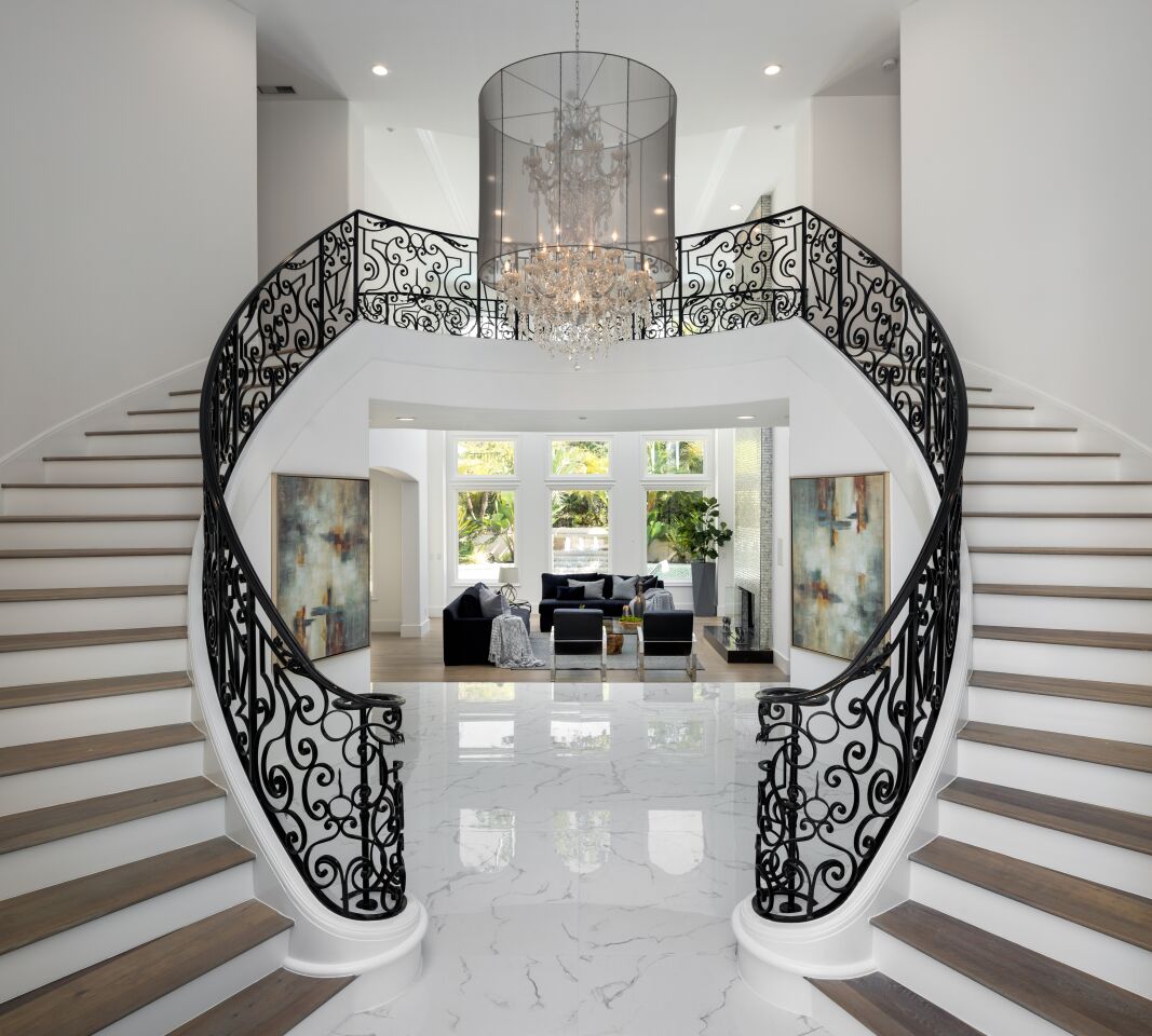 The foyer with dual staircases.