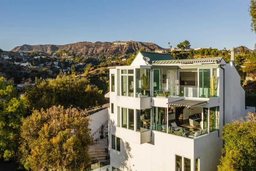 Spanning four stories, the 2,500-square-foot home takes advantage of the setting with walls of glass and multiple terraces.