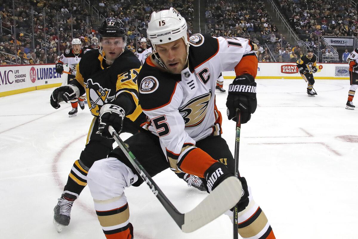 Ducks' Ryan Getzlaf (15) goes after the puck in the corner with Pittsburgh Penguins' Sam Lafferty (37) during the second period on Thursday in Pittsburgh.