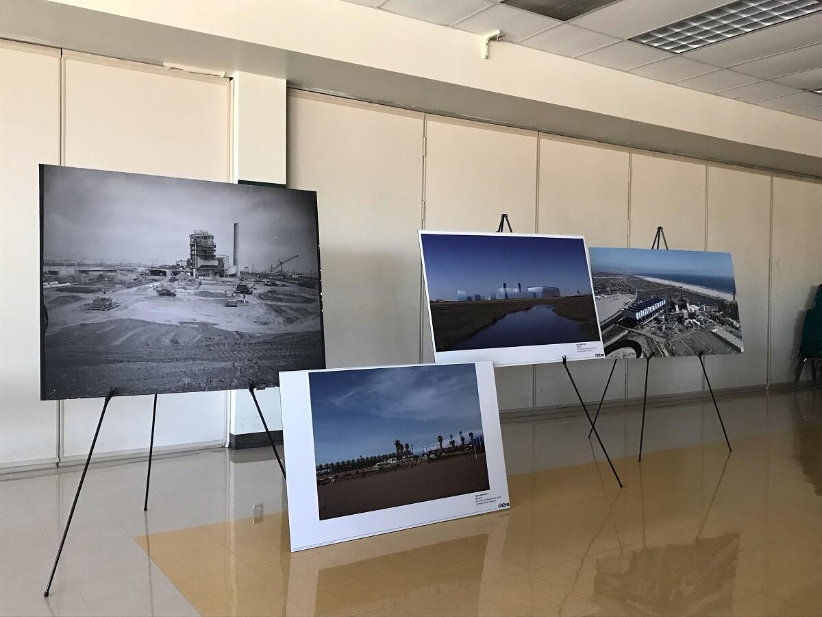 Poster boards showing historical photos of AES' current plant and renderings of the new one were on display Tuesday at Edison High School in Huntington Beach.